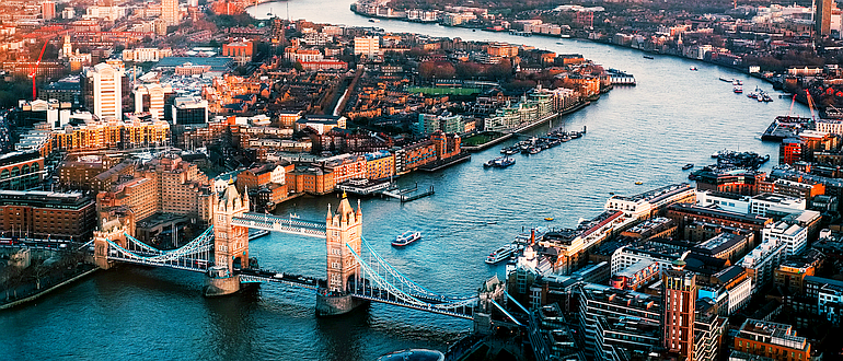 A long view of London and the snaking River Thames, with Tower Bridge in the foreground
